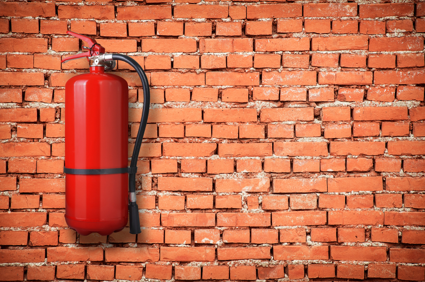 fire extinguisher on brick wall